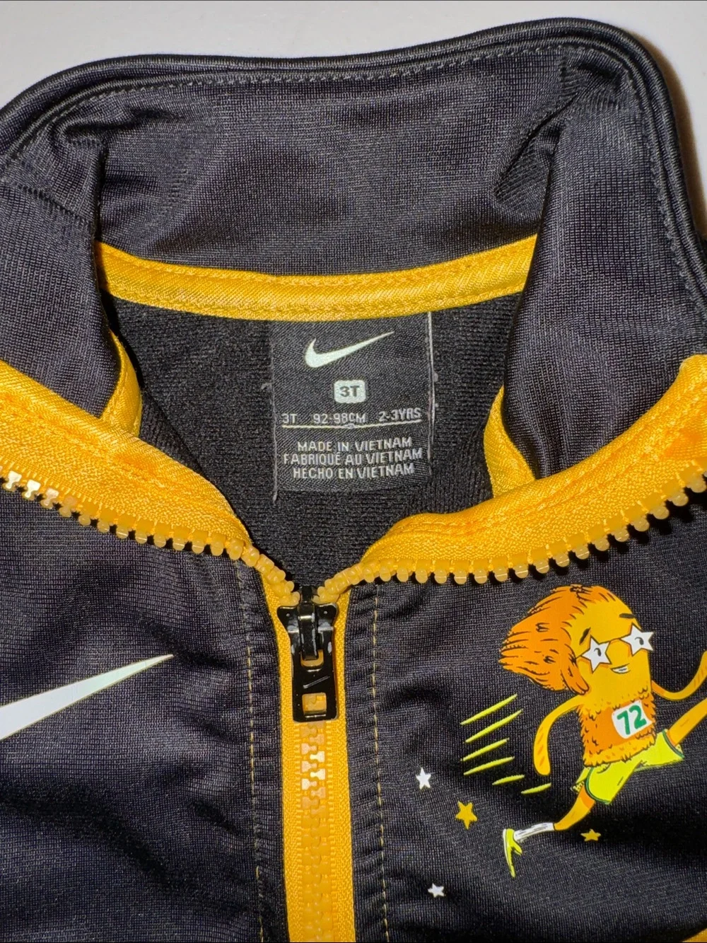 Nike Black and Gold Youth Zip-Up Track Jacket with Lion Runner Graphic